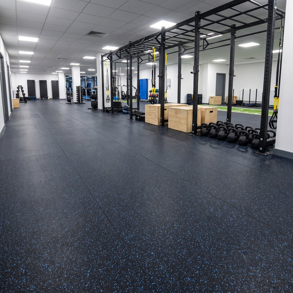 Blue Fleck rubber gym flooring rolls professionally fitted in a commercial gym functional training area