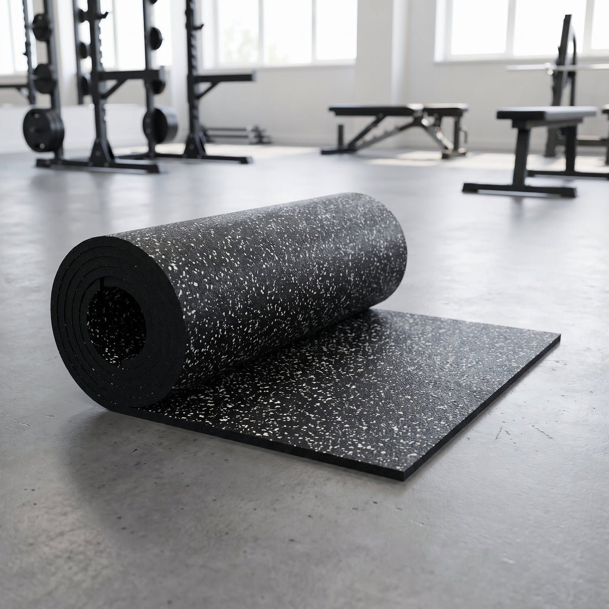 White Fleck commercial rubber gym flooring roll, 1m x 10m, partly unrolled on a gym floor