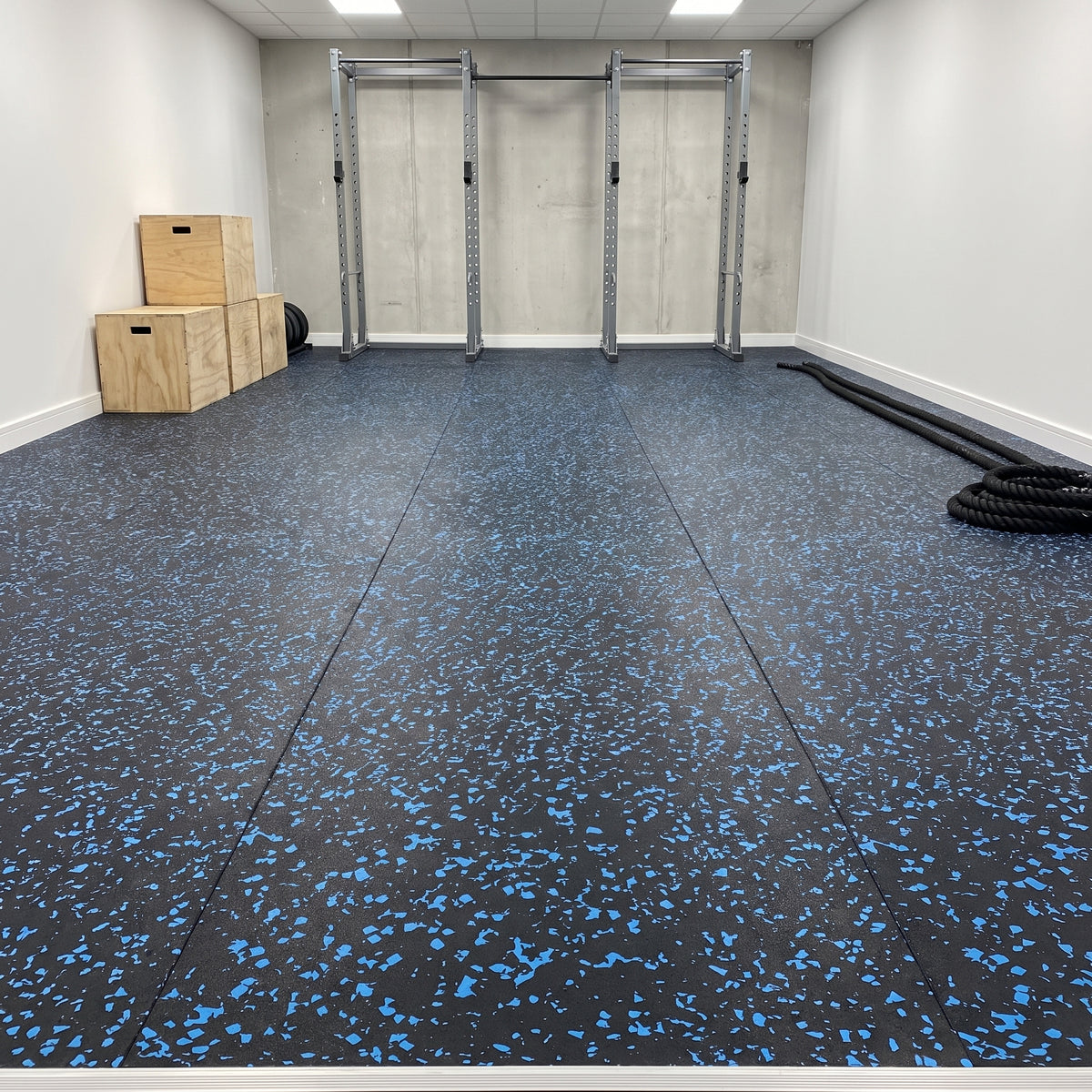 Blue fleck commercial rubber matting professionally fitted wall-to-wall in a commercial gym functional training zone