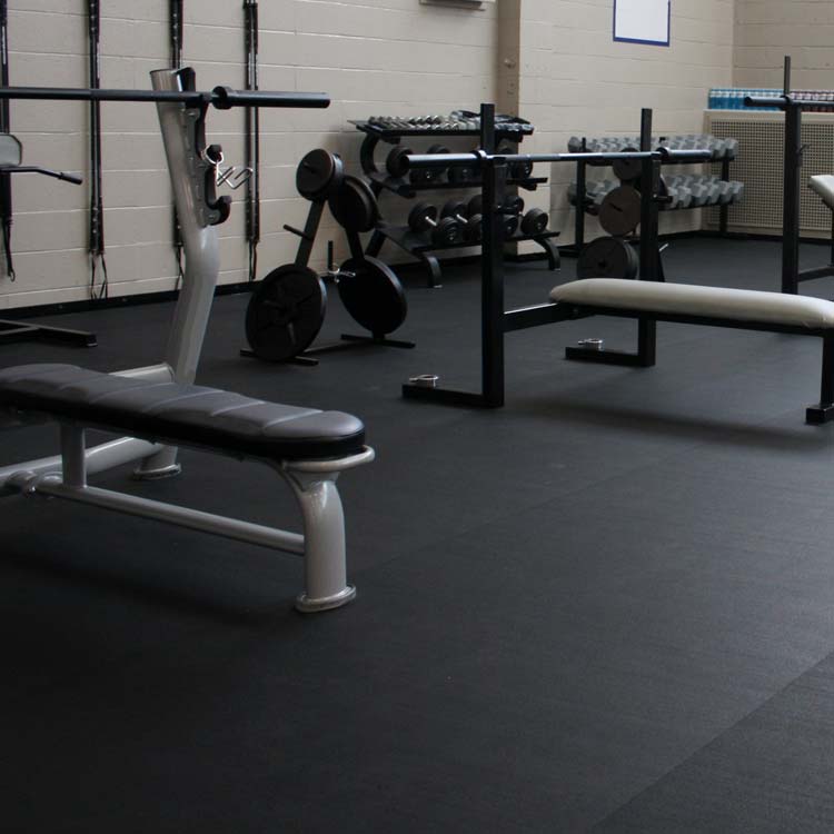 Black rubber gym flooring installed in a weights room