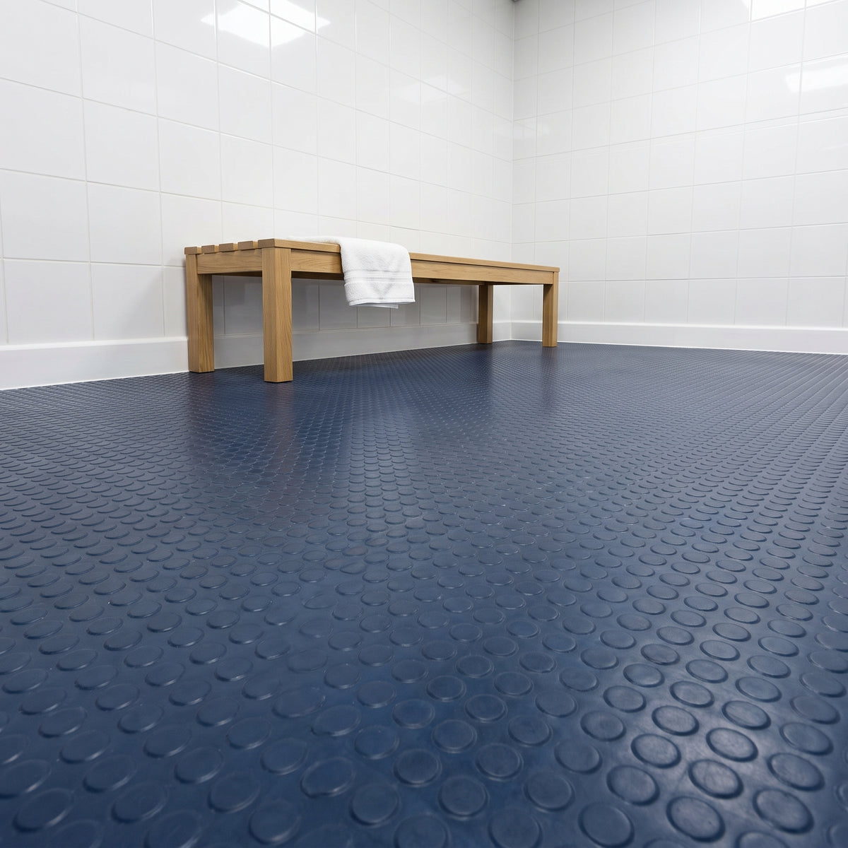 Deep Sea Blue round dot rubber flooring in a tiled changing room