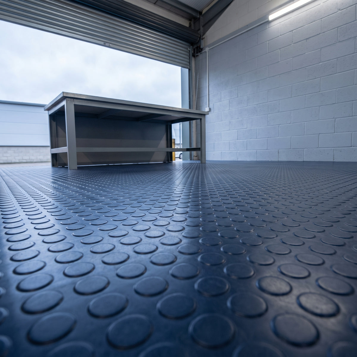 Deep Sea Blue round dot rubber safety flooring installed in a real-world setting