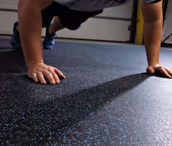 Close-up of Blue Fleck rubber gym flooring during a press-up